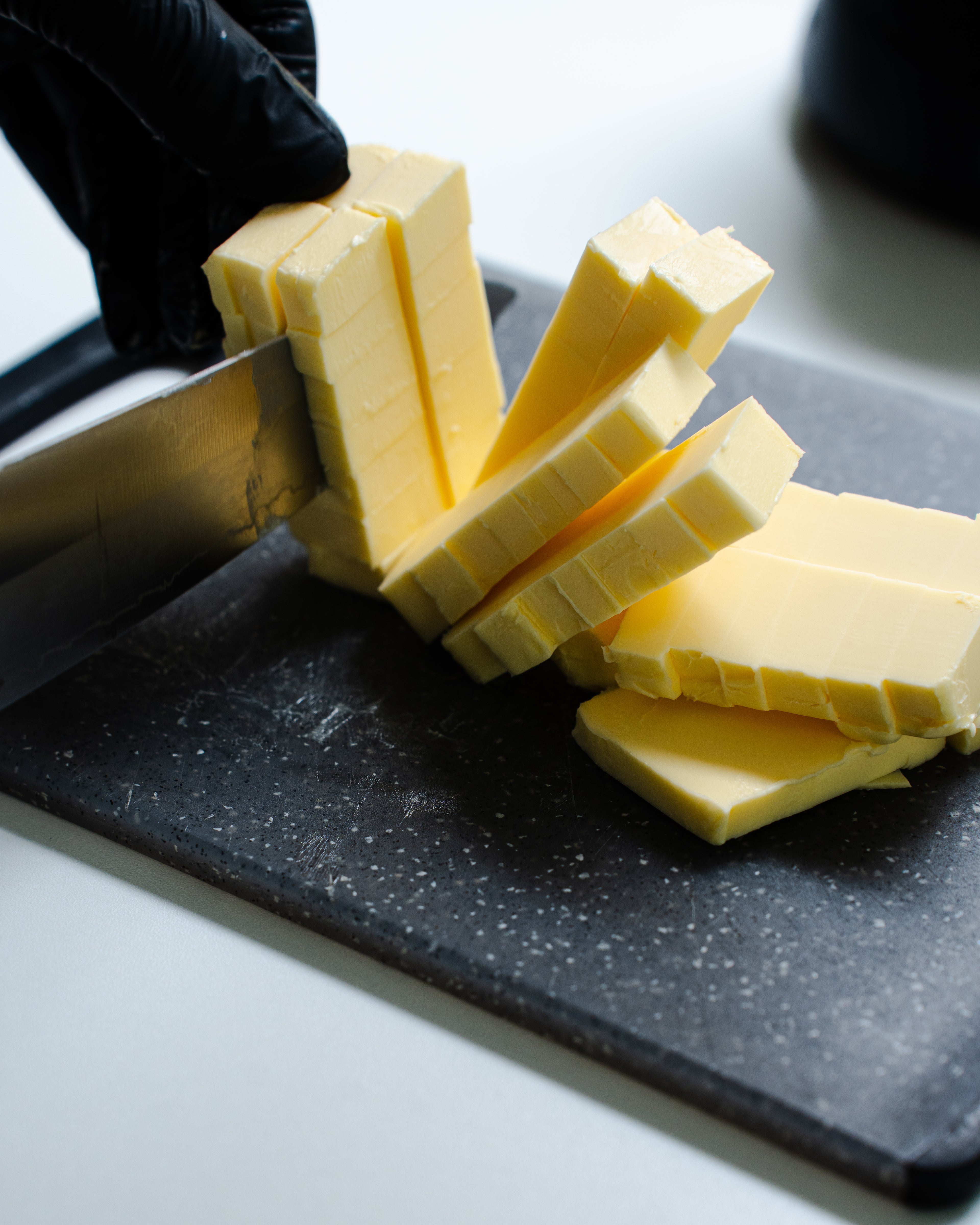 Bald bakes chef chopping butter